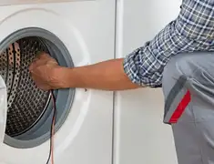 Dryer repair technician diagnosing and servicing a clothes dryer in Irvine, CA