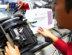 Vacuum repair technician servicing internal components on a workbench in Irvine, CA