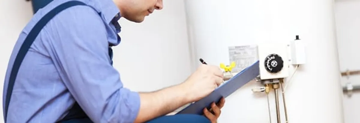 Water heater repair technician inspecting the unit and recording service notes in Irvine, CA